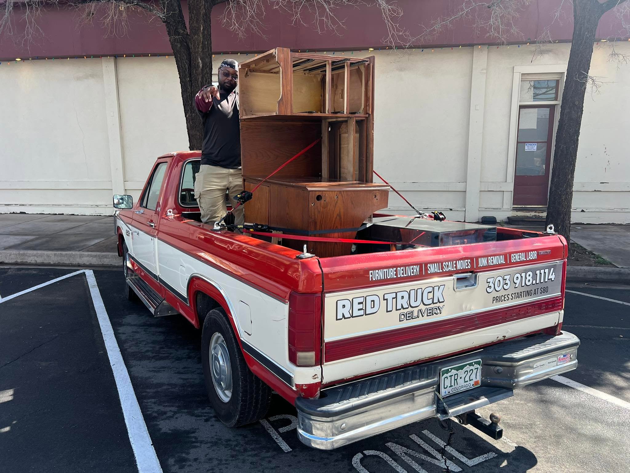 Red Truck Delivery crew loading junk furniture in Windsor, Colorado